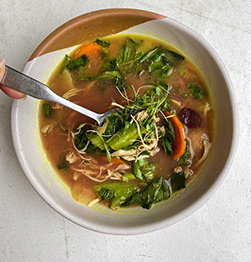 healthy golden bone broth with chicken and veg in Houston at Vibrant