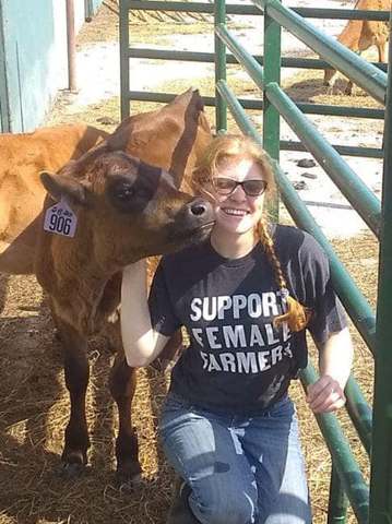Regenerative female Farmer Kyle with her happy pasture raised cows