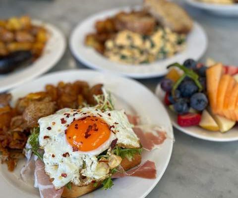 Beautiful orange yolks from Sonoma pasture-raised eggs, making a delicious nutrient-dense breakfast dish at Plow in San Francisco, CA