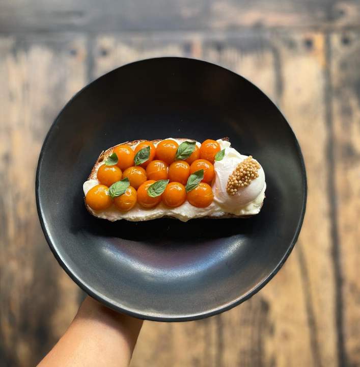 This ephemeral and delicious Summer Tartine features Sungolds fresh from the Chef's garden at healthy brunch spot Stowaway in Denver