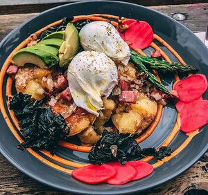 Poached eggs atop an array of deliciously prepared seasonal vegetables at Stowaway in Denver